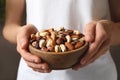 Woman holding bowl with organic mixed nuts Royalty Free Stock Photo