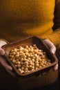 Woman holding a bowl of raw chickpeas close-up Royalty Free Stock Photo