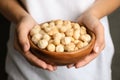 Woman holding bowl with shelled organic Macadamia nuts Royalty Free Stock Photo