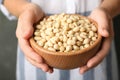 Woman holding bowl with shelled peanuts, Royalty Free Stock Photo