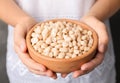 Woman holding bowl with shelled peanuts Royalty Free Stock Photo