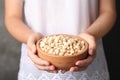 Woman holding bowl with shelled peanuts Royalty Free Stock Photo