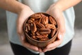 Woman holding bowl with shelled pecan nuts in hands Royalty Free Stock Photo