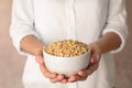 Woman holding bowl with shelled pine nuts Royalty Free Stock Photo