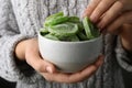 Woman holding bowl with slices of tasty kiwi, closeup. Royalty Free Stock Photo