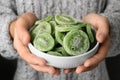 Woman holding bowl with slices of tasty kiwi. Dried fruit as healthy food Royalty Free Stock Photo