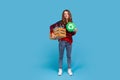 Woman holding box with empty plastic bottles and green recycling sign, fights environmental issues. Royalty Free Stock Photo