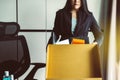 Woman holding box and equipment from work,Unemployment job concept