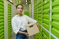 Woman Holding Box in Self Storage Unit