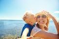 Woman holding boy on back kissing her Royalty Free Stock Photo