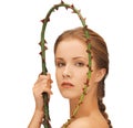 Woman holding branch with thorns
