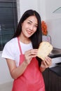 Woman holding a bread in kichen room