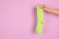 Woman holding bright sock and space for design