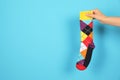 Woman holding bright sock and space for design