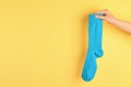 Woman holding bright sock and space