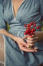 Woman holding a bucket of rose hips