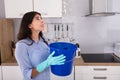 Woman Holding Bucket While Water Droplets Leak From Ceiling Royalty Free Stock Photo