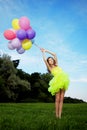 Woman holding bunch of colorful air balloons Royalty Free Stock Photo