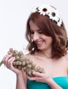 Woman holding bunch of grapesand looking on it Royalty Free Stock Photo