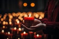 Closeup of woman hands holding burning candle in church. Religion concept Royalty Free Stock Photo