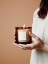 Woman holding burning candle, design and branding ready candle jar mockup with female hands, no face Royalty Free Stock Photo