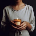 Woman holding burning candle, design and branding ready candle jar mockup with female hands, no face Royalty Free Stock Photo