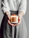 Woman holding burning candle, design and branding ready candle jar mockup with female hands, no face Royalty Free Stock Photo