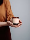 Woman holding burning candle, design and branding ready candle jar mockup with female hands, no face Royalty Free Stock Photo