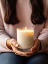 Woman holding burning candle, design and branding ready candle jar mockup with female hands, no face Royalty Free Stock Photo