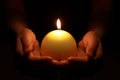 Woman holding burning candle in hands on black background, closeup Royalty Free Stock Photo