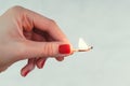 Woman holding a burning match Royalty Free Stock Photo