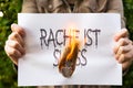 Woman is holding burning paper