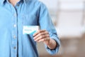 Woman holding business card indoors, closeup Royalty Free Stock Photo