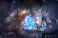 Woman holding business Christmas tree, made of neon light and surrounded by communication icons