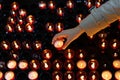 A girl is holding candle and praying near altar in church. Royalty Free Stock Photo