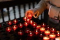 A girl is holding candle and praying near altar in church. Royalty Free Stock Photo
