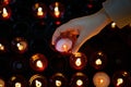 A girl is holding candle and praying near altar in church. Royalty Free Stock Photo