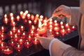 A girl is holding candle and praying near altar in church. Royalty Free Stock Photo