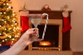 Woman holding candy cane martini Royalty Free Stock Photo