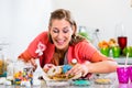 Woman holding candy stick and picking donut