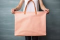 woman holding canvas bag mockup color peach fuzz