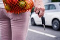 Woman holding car key in hand after shopping at supermarket Royalty Free Stock Photo