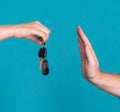 Woman holding car key, man raising hand in a stop gesture Royalty Free Stock Photo