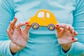 Woman holding a car-shaped cookie