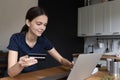 Woman holding card using laptop enjoy online shopping at home Royalty Free Stock Photo