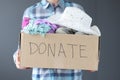 Woman holding cardboard box with donations in her hand closeup