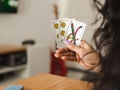 Woman holding cards while playing Truco, an Argentinian card game. Close up Royalty Free Stock Photo