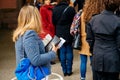 Woman holding carte electorale waiting to vote