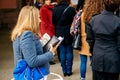 Woman holding carte electorale waiting to vote