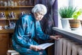 Woman holding cash in front of heating radiator. Payment for heating in winter. Selective focus.